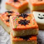 Halloween Frosted Sugar Cookie Bars topped with colorful icing and sprinkles